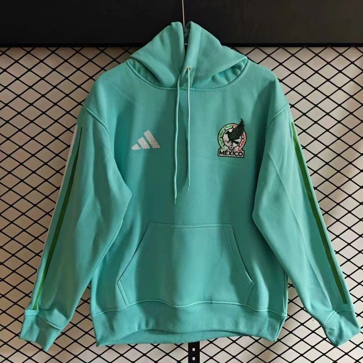 Show your support for Germany national football team with this casual pullover hoodie. Front kangaroo pocket, iconic Germany national‑color sleeve stripes, official team crest on chest. Soft fleece interior, perfect for match‑day, training and daily wear.
